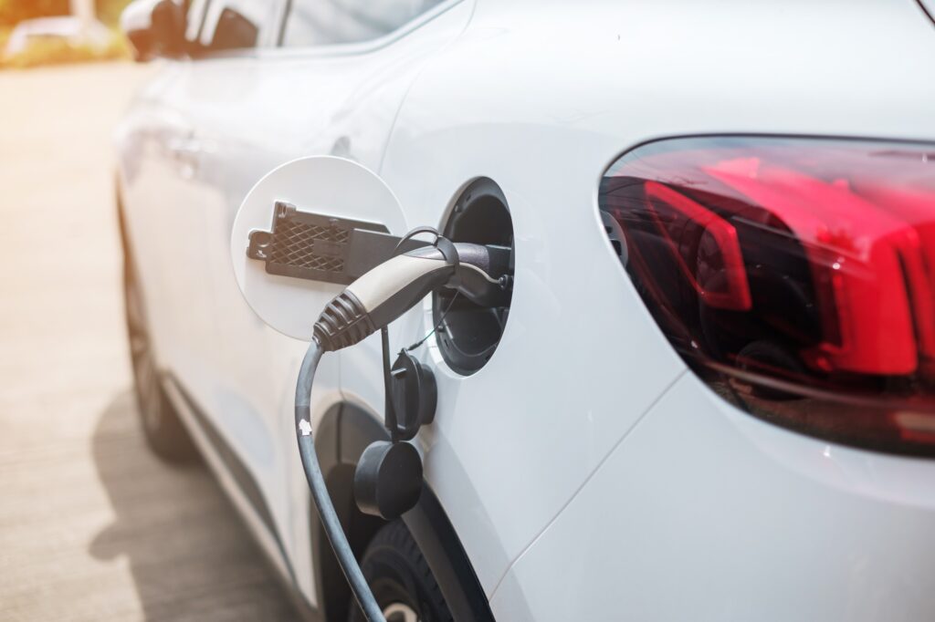 Electric car charging battery at EV charger station