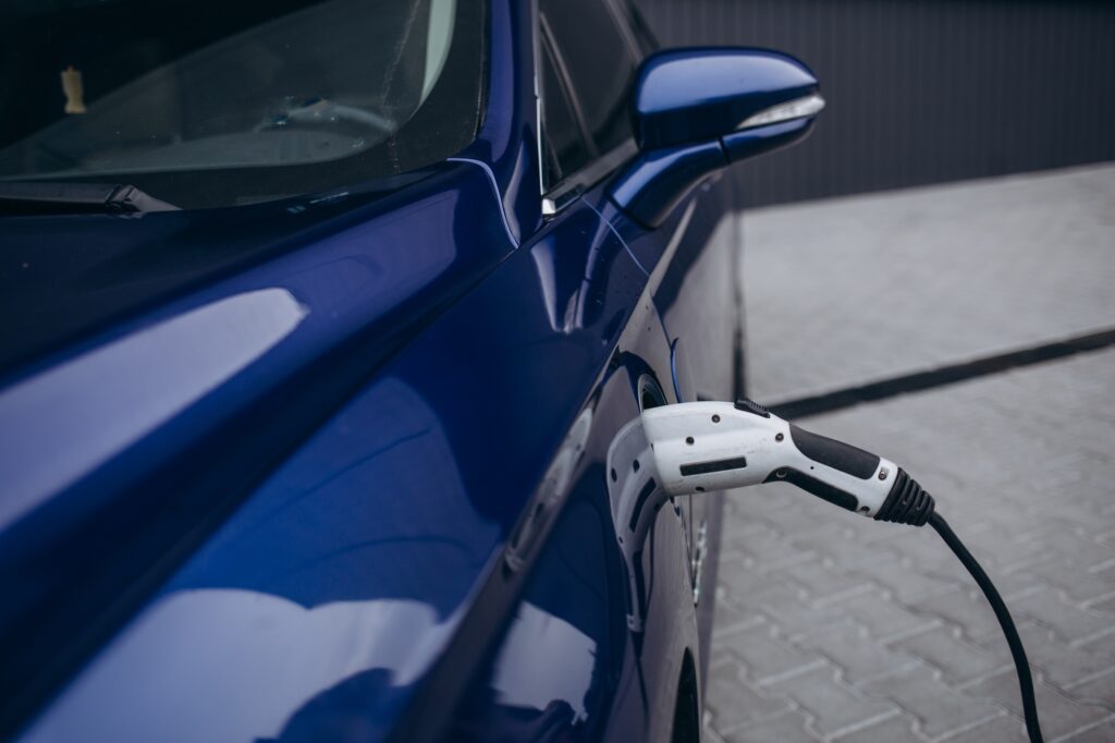 EV Car or Electric car at charging station with the power cable supply plugged